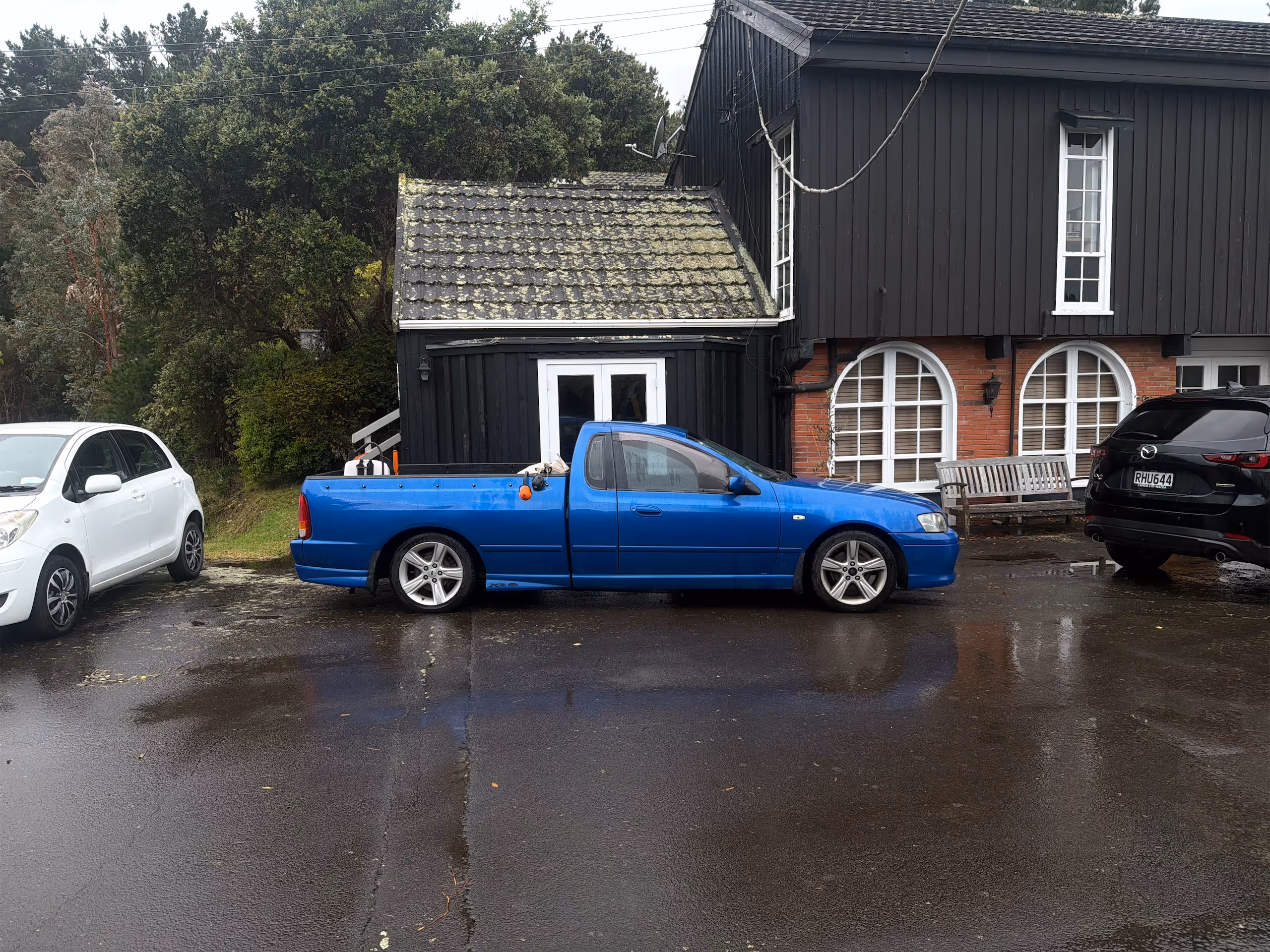 a blue truck parked in front of a house